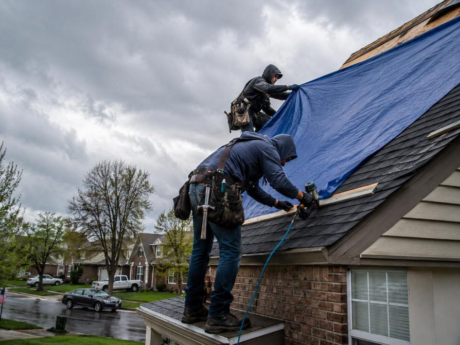 er 911 roof tarp installation in progress aspen hill md 2026
